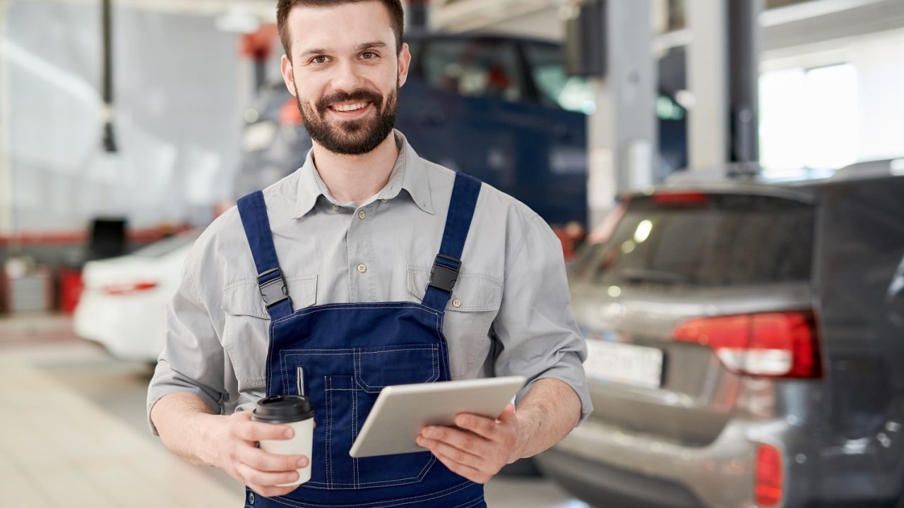 smiling-worker-in-car-service-2021-09-24-03-49-06-utc-min.jpg